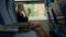 Young attractive woman sits in train car. Girl drinking coffee in train