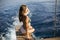 Young attractive woman sitting on luxury yacht floating at sea