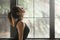 Young attractive woman in upward facing dog pose, window backgro