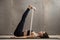 Young attractive woman in Urdhva Prasarita Padasana pose with st