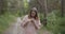 Young attractive woman using smartphone to navigate in a summer forest