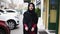 Young attractive woman wearing hijab walking in the street in city and smiling. Slowmotion shot