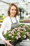 Young attractive woman working at the plants nursery