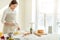 Young awesome pleasant girl baking a pie in the kitchen.