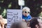 Young baby boy on dad shoulder holding demonstration sign banner