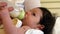 Young baby drinking from a milk bottle