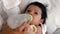 Young baby drinking from a milk bottle