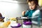 Young baby girl helps prepare a cake using a food processor