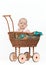 Young baby girl in a wicker pram