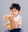 Young baby son hold with doll bear