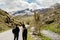 Young backpacker hiker couple enjoying relaxing mountain hike.Active hiking trip vacation.Reconnecting with nature.Climbers