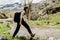 Young backpacker hiker woman enjoying relaxing mountain hike.Active hiking trip vacation.Walking by the mountain stream.Climber