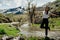 Young backpacker hiker woman enjoying relaxing mountain hike.Active hiking trip vacation.Walking by the mountain stream.Climber