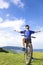 Young backpacker sitting on a mountain bike and relaxing pose