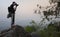 Young backpacker,Traveler taking photos at Sunset, Luang Prabang hilltop