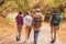 Young backpackers in autumn forest