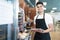 Young baker counting bread in a bakery