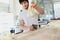 A young Baker puts a portion of dough on a wooden table. The process of making tortillas. The person is out of focus. Yeast dough