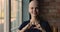 Young bald cancer patient woman showing with fingers heart shape