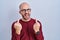 Young bald man with beard standing over white background wearing glasses showing middle finger doing fuck you bad expression,