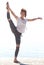 Young balerina dancing on the beach