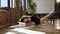 Young ballerina doing stretching sitting on a floor. Gymnast for training. Attractive girl in black tutu is doing