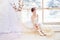 Young ballerina girl is preparing for a ballet performance. Little prima ballet. Girl in a white ball gown and Pointe