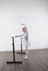 Young ballerina girl in a white tutu. Adorable child dancing classical ballet in a white studio with wooden floor. Children dance.