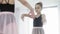 Young ballerina looking at mirror and doing exercises
