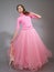 Young ballerina in a pink dress shows modern dance