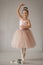 Young ballerina stands on pointes