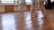 Young ballerinas do pirouettes in pairs during ballet lesson.