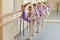 Young ballerinas doing exercises in studio.