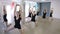 Young ballerinas dressed in black uniform stand in pose in dancing class.