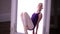 Young ballet dancer performing exercise, while sitting on floor. teenage girl stretching her legs, on white background