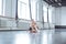 Young ballet dancer tying ribbons of pointe in studio active lifestyle