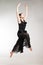 Young ballet dancer wearing black transparent dress jumping