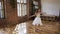 Young ballet dancer in white dress and ballet shoes performs elements of ballet. Attractive dancer performs elements of