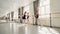 Young ballet dancers are practising leg positions at ballet bar under guidance of professional ballerina strict teacher