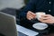 The young bank employee works on a laptop at lunchtime.