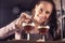 Young barmaid smiles after making two espresso martini short drinks with a coffee