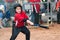 Young baseball player hitting ball off a tee