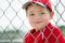 Young baseball player sitting in dugout