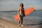 Young beach lifeguard standing on the sand with life-saving