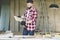 Young bearded businessman,builder,repairman,carpenter,architect, designer, handyman dressed in plaid shirt, goggles and