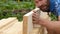 Young bearded carpenter checks the quality of the boards. slow motion