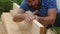 Young bearded carpenter checks the quality of the boards. slow motion