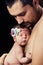 Young bearded father gently holds on his chest newborn baby daughter