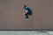 Young bearded guy sortsman jumping on the background of a pink street wall