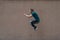 Young bearded guy sortsman jumping on the background of a pink street wall